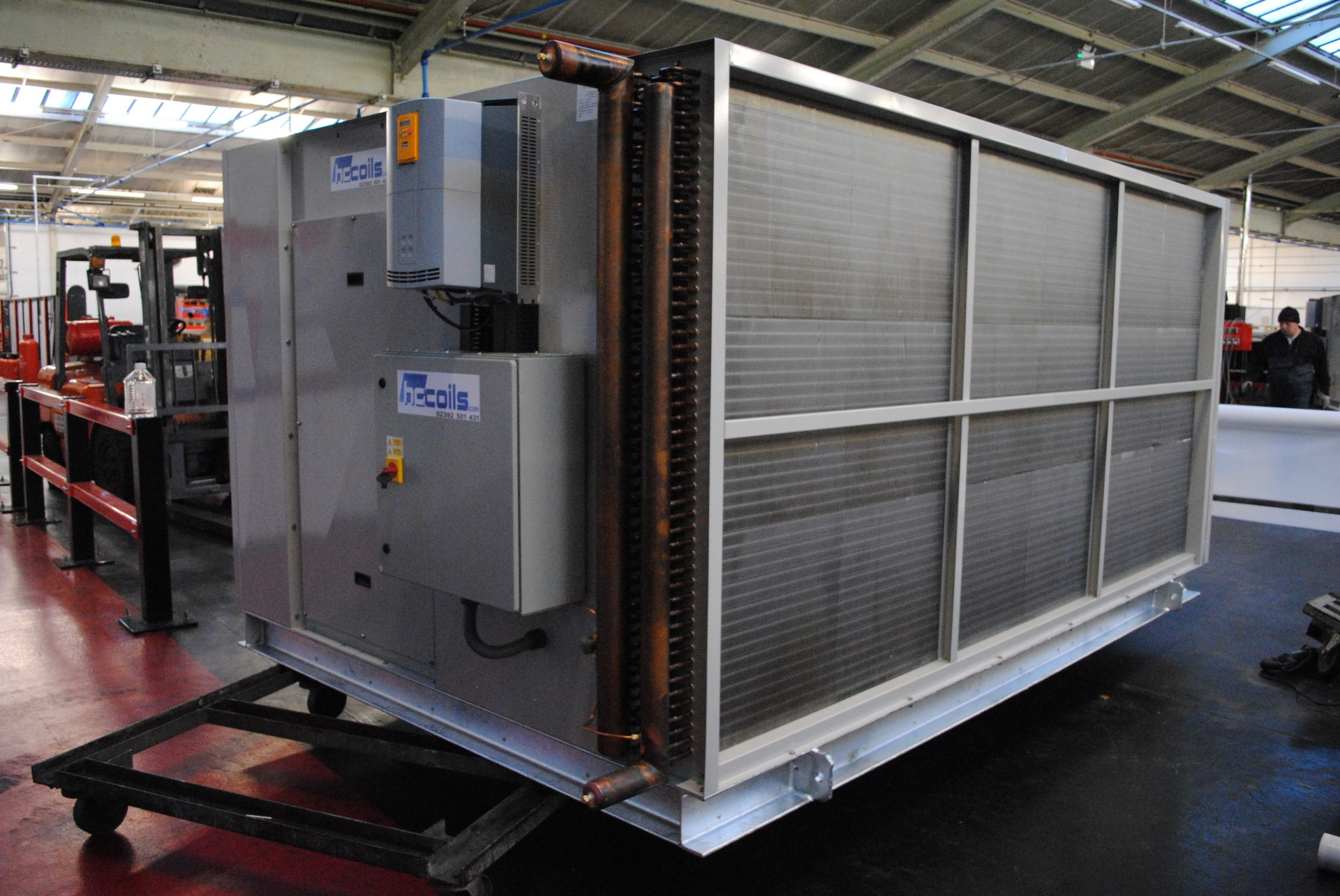 Large centrifugal fan dry air cooler with copper headers and aluminium fins on factory floor