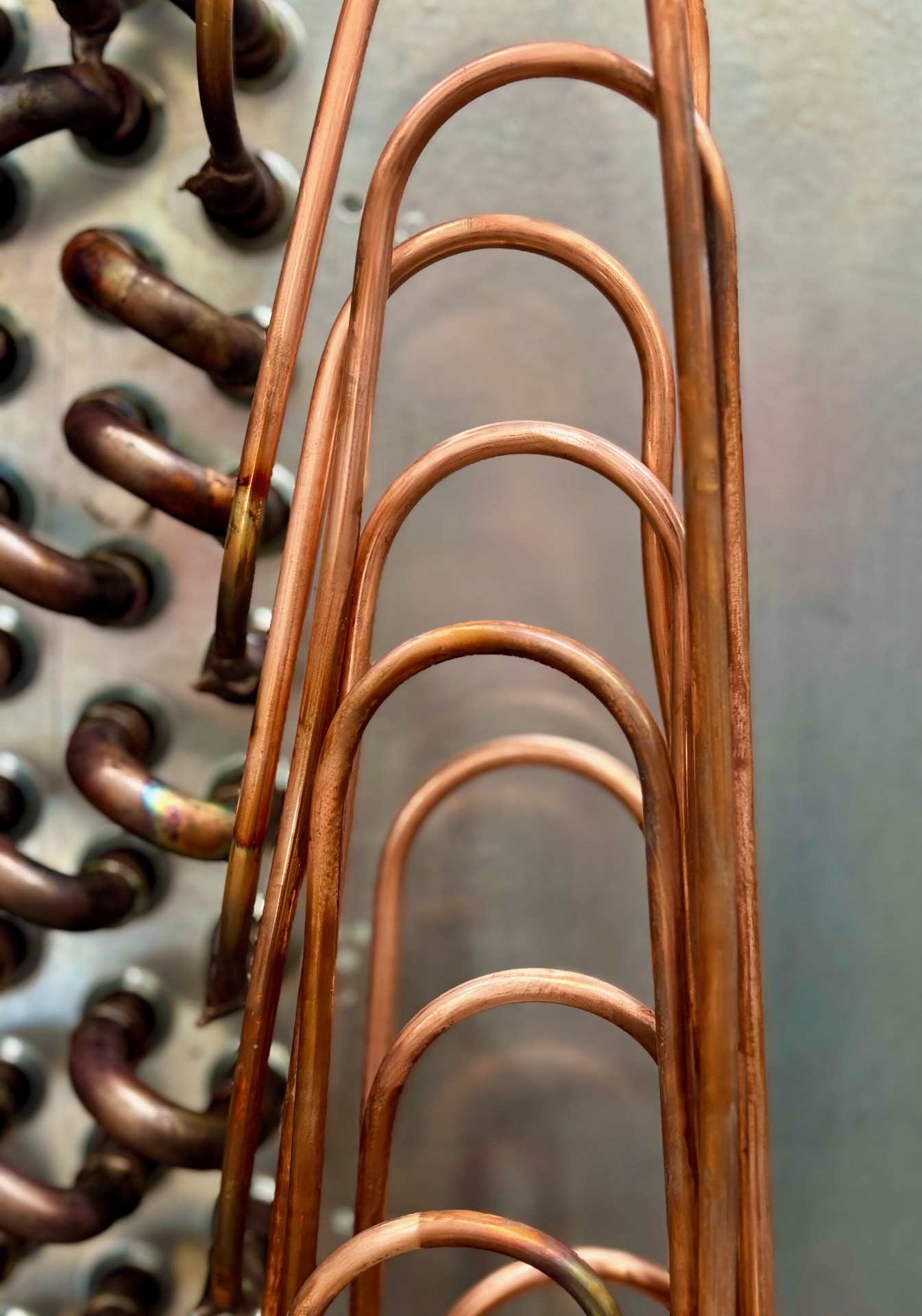 Copper U-bend return fittings ready for assembly in the HC Coils workshop