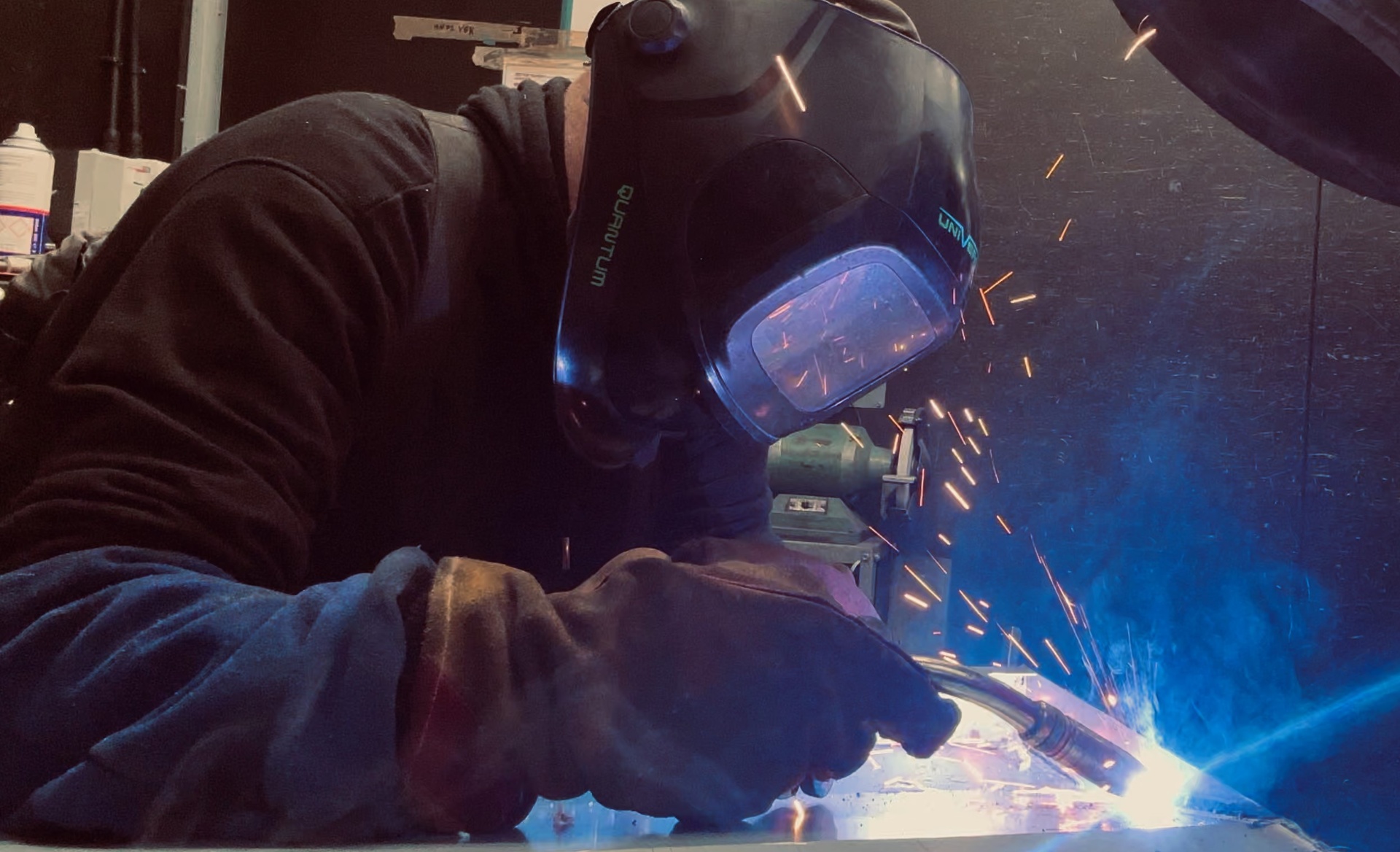 HC Coils welder MIG welding a coil casing with dramatic blue arc and sparks