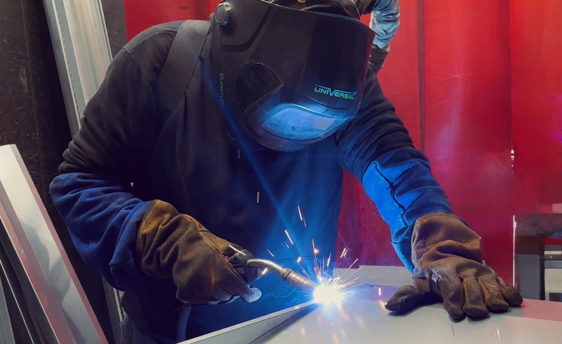 Skilled welder fabricating sheet metal components at HC Coils