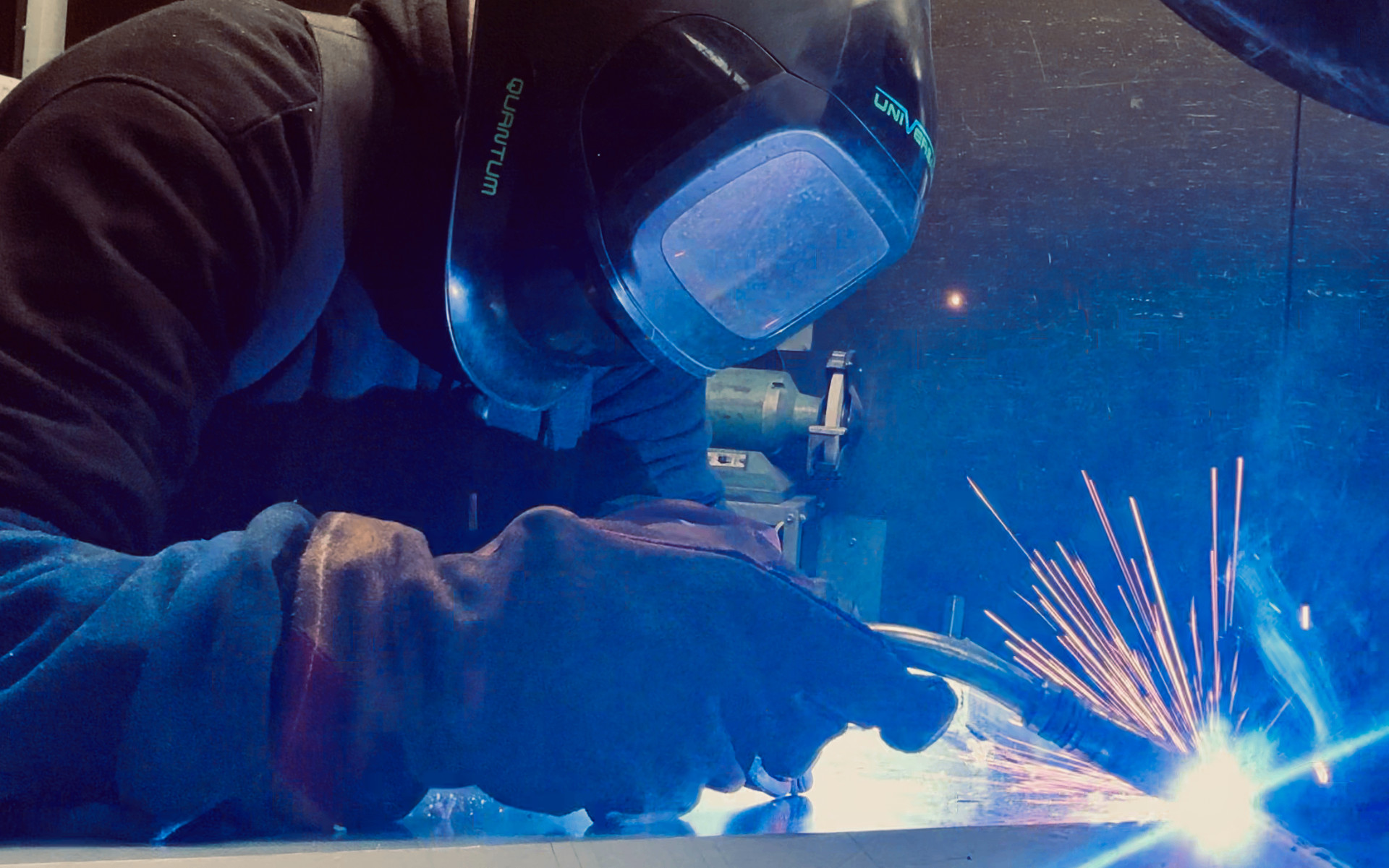 MIG welding with sparks in casing fabrication bay