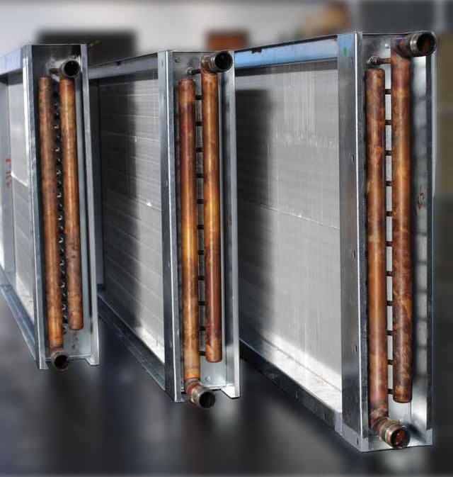 Two bespoke hot water heating coils with copper tubes and galvanised casings in the HC Coils workshop