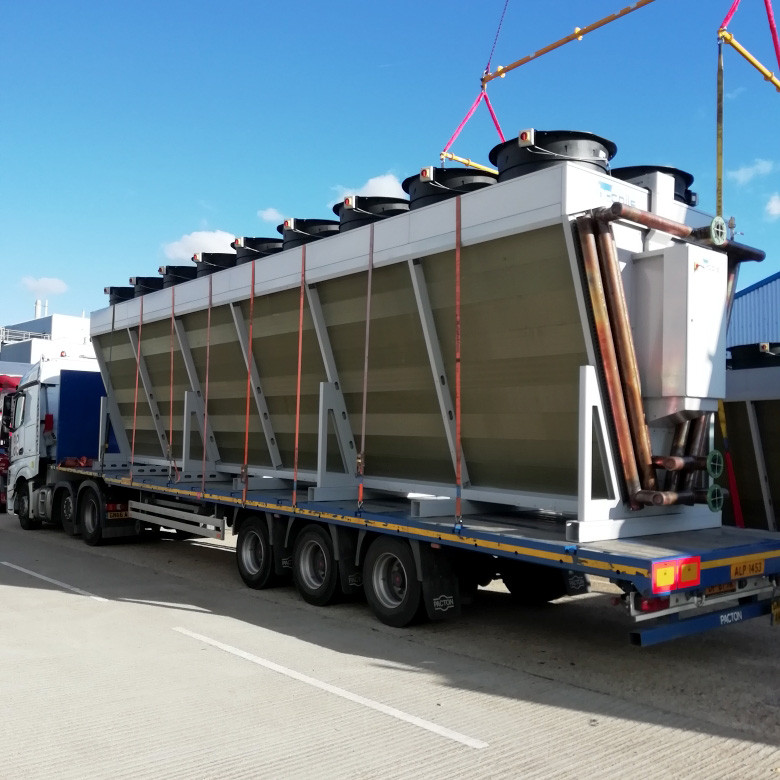 Large V-configuration dry cooler being crane-loaded for delivery