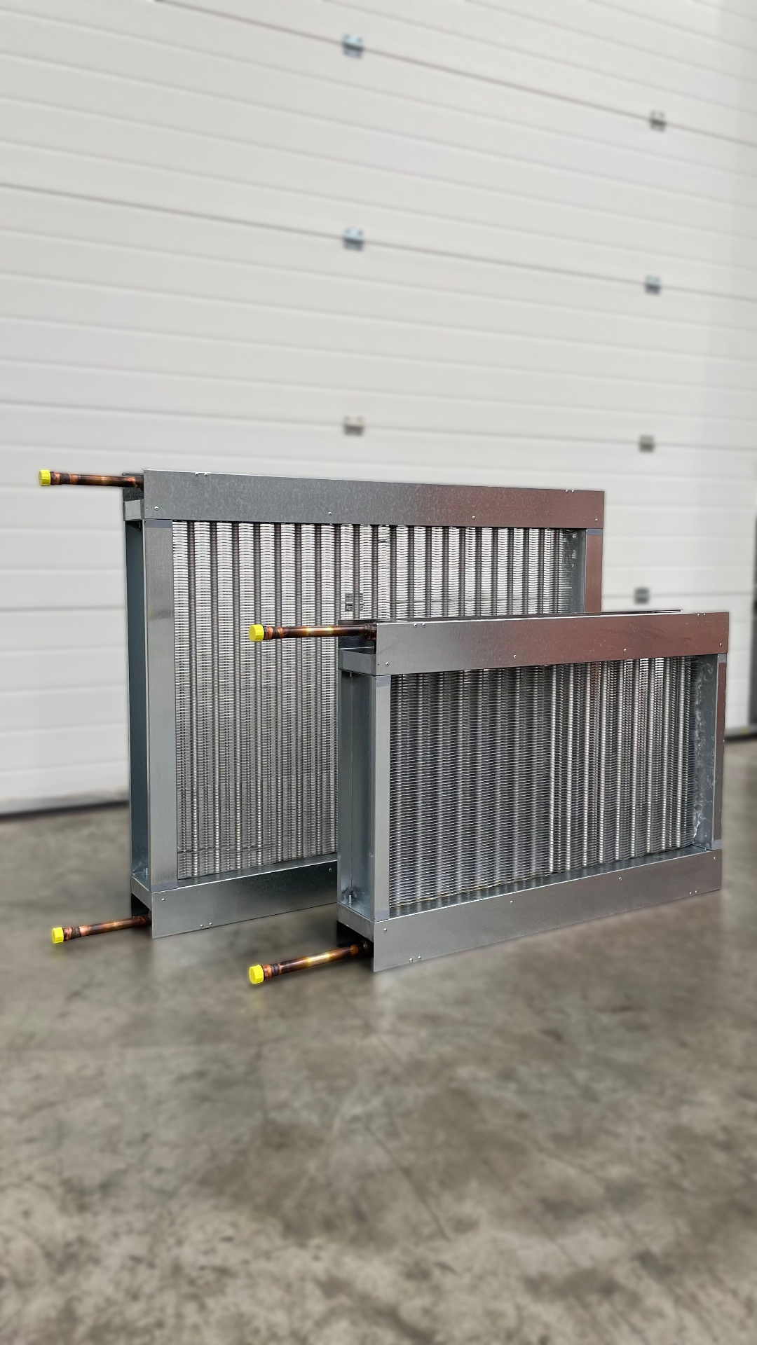 Two bespoke steam coils with galvanised casings and copper connections in the HC Coils workshop
