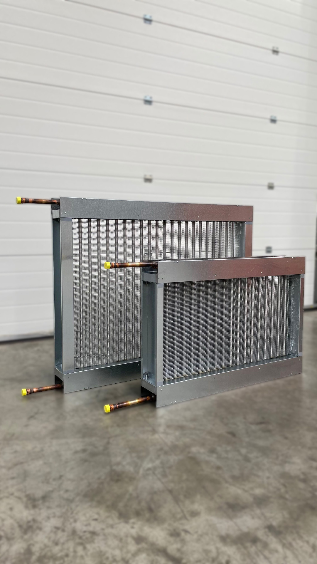 Two bespoke steam coils with galvanised casings and copper connections in the HC Coils workshop